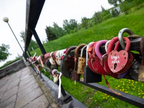 Bridge of love with multi-colored padlocks of the newlyweds. Padlocks with ke Stock Photos