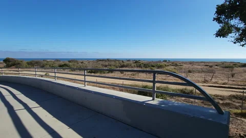 Bridge metal rail with a nice beach view horizon in a sunny day Stockbeeldmateriaal 201280889