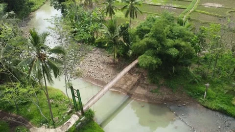 A bridge that is no longer fit in the middle of a river flowing Stock Footage 244644599