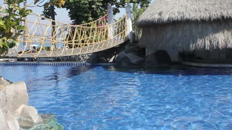 Bridge over blue pool to cabana in mexico Stock Footage 1067322