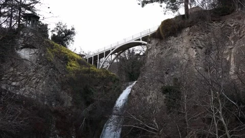 Bridge over canyon with waterfall in natural landscape Stock Footage 331704076