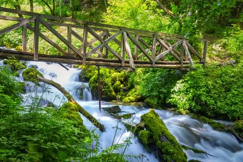 Bridge over cascade river Stock Photos