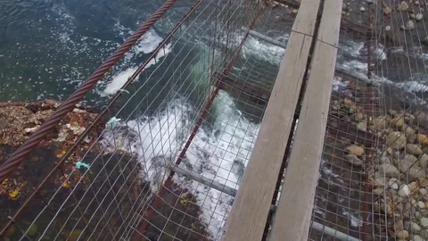 The bridge over the clear crystal river in Tegudon, Sabah. Stock Footage 107888973