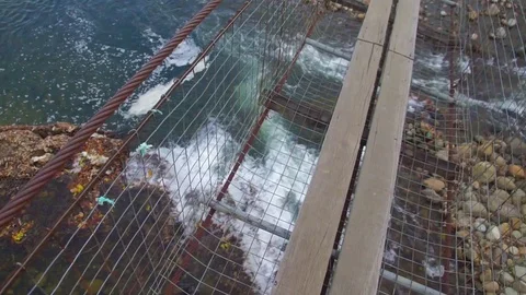 The bridge over the clear crystal river in Tegudon, Sabah. Stock Footage 107888977