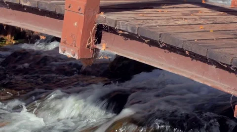 Bridge over clear mountain stream Stock Footage 45729859