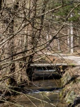 Bridge over creek next to a hiking trail Stock Photos