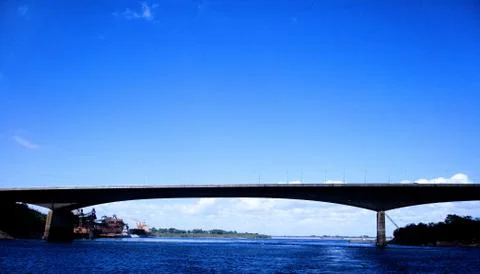 Bridge over deep blue river and clear blue sky Stock Photos