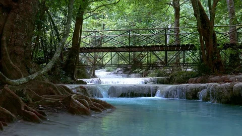 Bridge over the Erawan cascade waterfall. Kanchanaburi National Park, Thailand Stock Footage 112933158