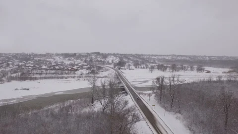 Bridge over a frozen river in winter, aerial photography Stock Footage 85563323