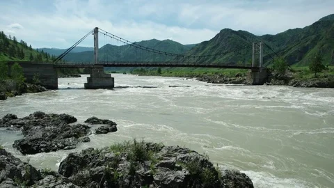 Bridge over Katun river in flood. Altay, Russia. Stock Footage 69773183