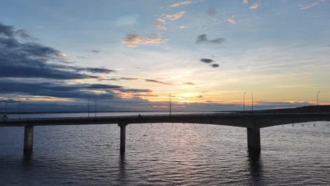 Bridge over lagoon at sunset with dramatic sky aerial 4K Stock Footage 339864039