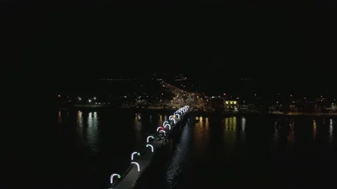 A bridge over a large river illuminated with white lights Stock Footage 146341212