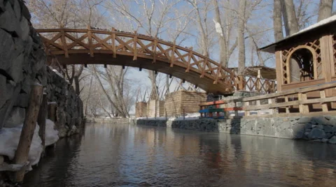 Bridge over a large stream in winter Stock Footage 61457288