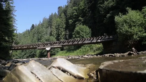 Bridge over mountain river Stock Footage 73016723