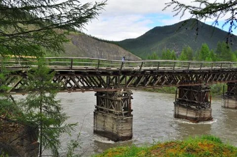 Bridge over the mountain river. Stock Photos