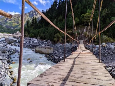 A bridge over a mountain river. Stock Photos