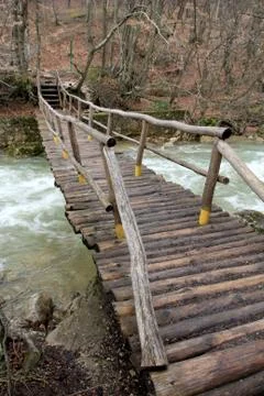 Bridge over mountain stream Stock Photos