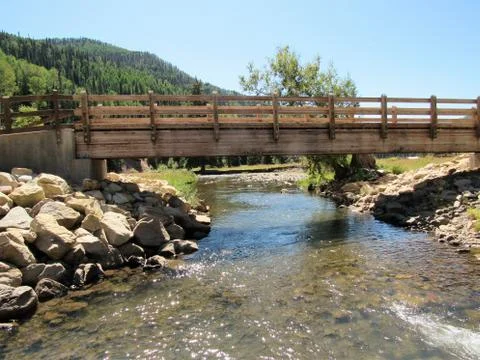 Bridge over a mountain stream Stock Photos