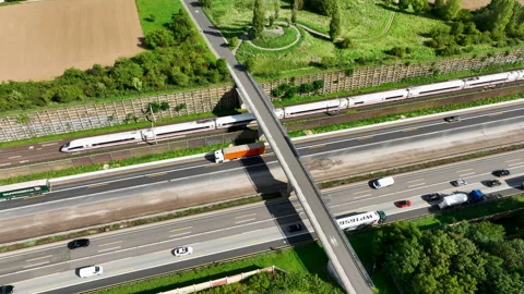 Bridge over a multiple lane highway, high speed train - aerial view Видео 250893746