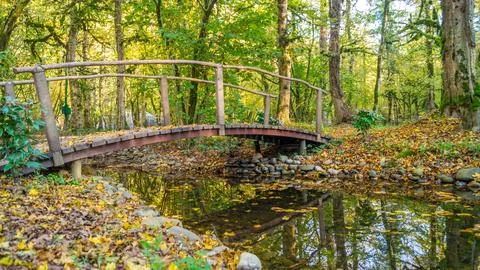 A bridge over a pond in the mountains Stock Photos