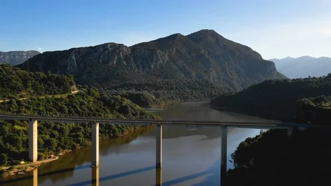 Bridge over the river and green mountains in background Stock Footage