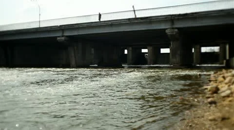 Bridge over the river and the silhouette of a passerby 스톡 동영상 22304559