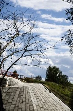 Bridge over the river with bare trees and blue sky in the background Stock Photos