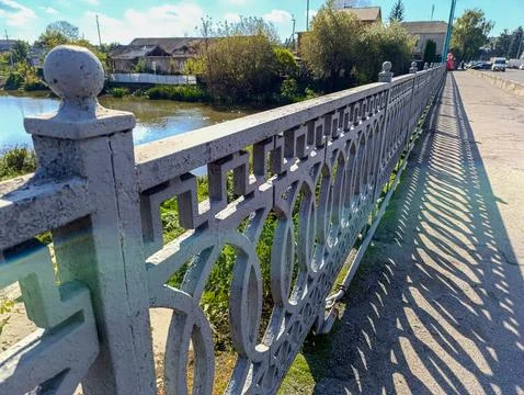 A bridge over a river with a bridge railing Stock Photos