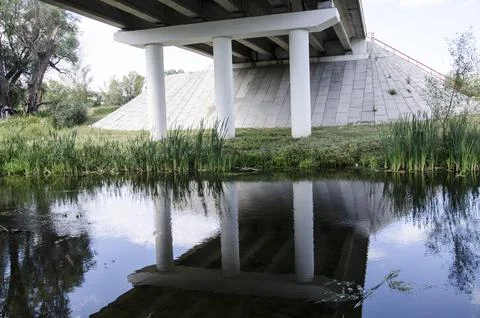 Bridge over the river. The bridge is reflected in the water. Stock Photos