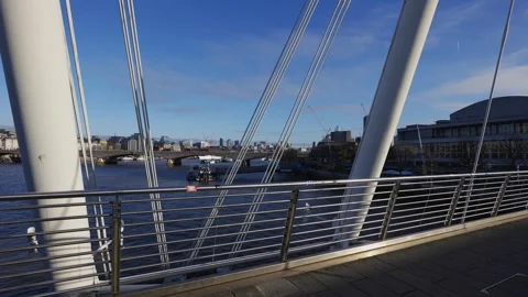 A bridge over a river with a city in the background Stock Footage 297860177
