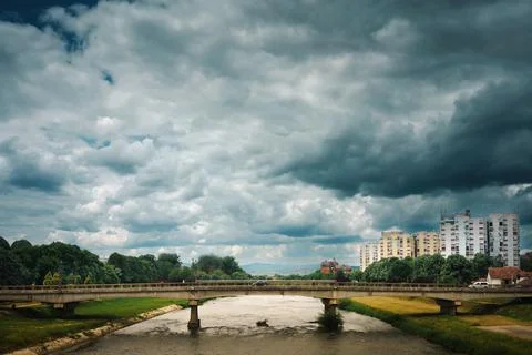 A bridge over a river on a cloudy spring day Stock-Fotos