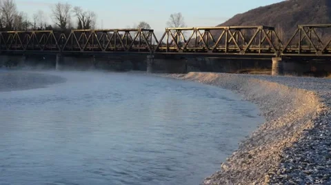 Bridge over the river at dawn in winter Stock Footage 63456056