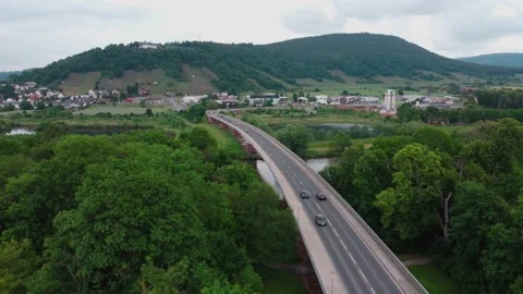 Bridge over the river leading to a small town Vídeos de archivo 155551775
