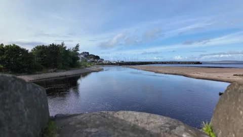 Bridge Over River Margy at Ballycastle Flowing into Ocean on Sunny Day Stock-Footage 317237670
