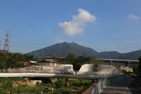 A bridge over a river with a mountain in the background Stock Photos