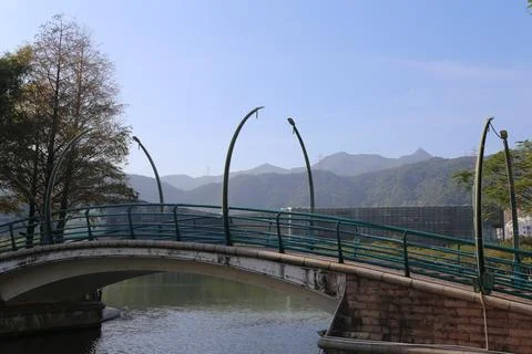 A bridge over a river with a mountain in the background Foto stock