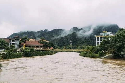 Bridge over the river with mountains in background in Vang Vieng, Laos. Stock Photos