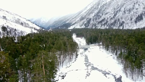 Bridge over the river in the mountains a car rides across the bridge in wint Stock Footage 168279149