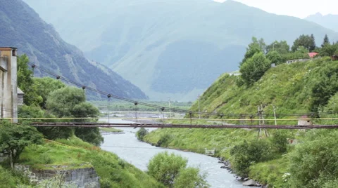 Bridge over river in mountains 스톡 동영상 61645629