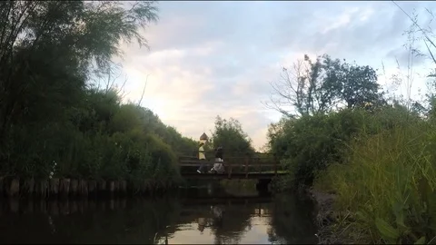 Bridge over the river in park in the evening timelapse Stock Footage 78017592