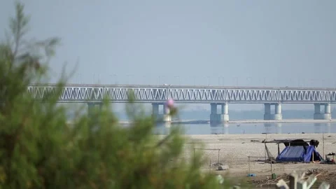 Bridge over river with sandy shore and tent Stock-Footage 331277480
