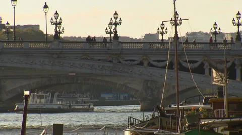 Bridge over river Seine in Paris with people walking and boat crossing Stock Footage 59311455