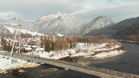 Bridge over a river with snowy mountains in the background Stock Footage 232367115