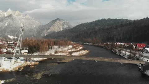 Bridge over a river with snowy mountains in the background Stock Footage 232367239