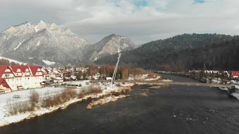 Bridge over a river with snowy mountains in the background Stock Footage 232367323