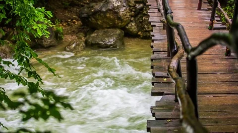 On the bridge over the river there is a man 스톡 동영상 79979669