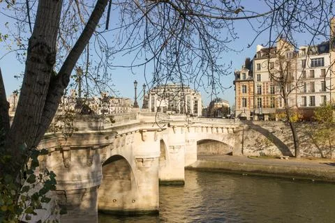 A bridge over a river with a tree in the backgroundA fence with many locks on a Stock Photos