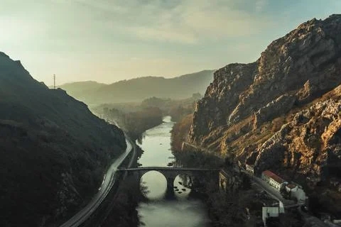 A bridge over a river in a vale Stock Photos
