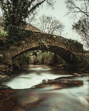 A bridge over a river in a vale Stock Photos