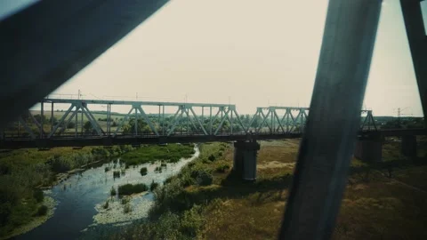 Bridge over the river from the window of a speeding train. Passion for travel. Video stock 148168697